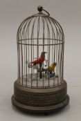 An early 20th century brass clockwork automaton musical bird cage. 26 cm high.