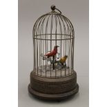 An early 20th century brass clockwork automaton musical bird cage. 26 cm high.