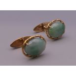 A pair of 14 ct gold jade cufflinks. 2 cm high. 10.3 grammes total weight.