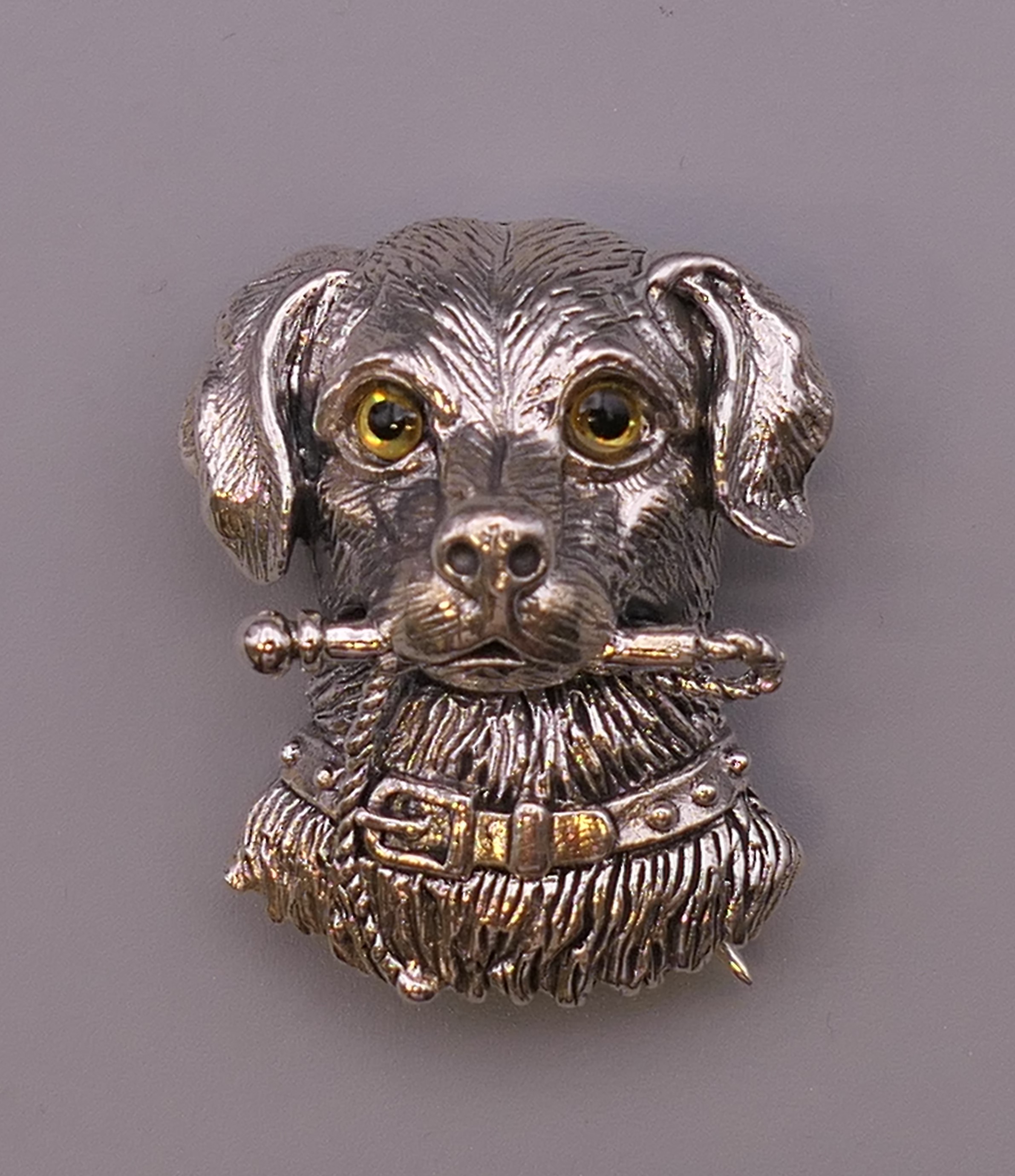 A silver dog form brooch. 3 cm high.