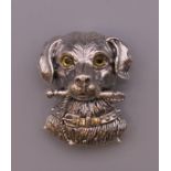 A silver dog form brooch. 3 cm high.