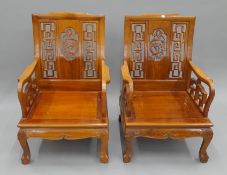 A pair of Chinese carved wooden chairs. 64 cm wide.