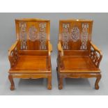 A pair of Chinese carved wooden chairs. 64 cm wide.