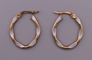 A pair of 9 ct gold and enamel earrings. 2 cm high. 1.2 grammes total weight.