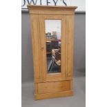 A Victorian pine single door mirrored wardrobe. 97.5 cm wide.