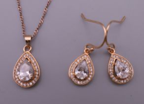 A boxed silver pendant and matching earrings.