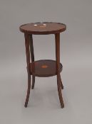 An Edwardian inlaid mahogany two tier side table. 55 cm high.