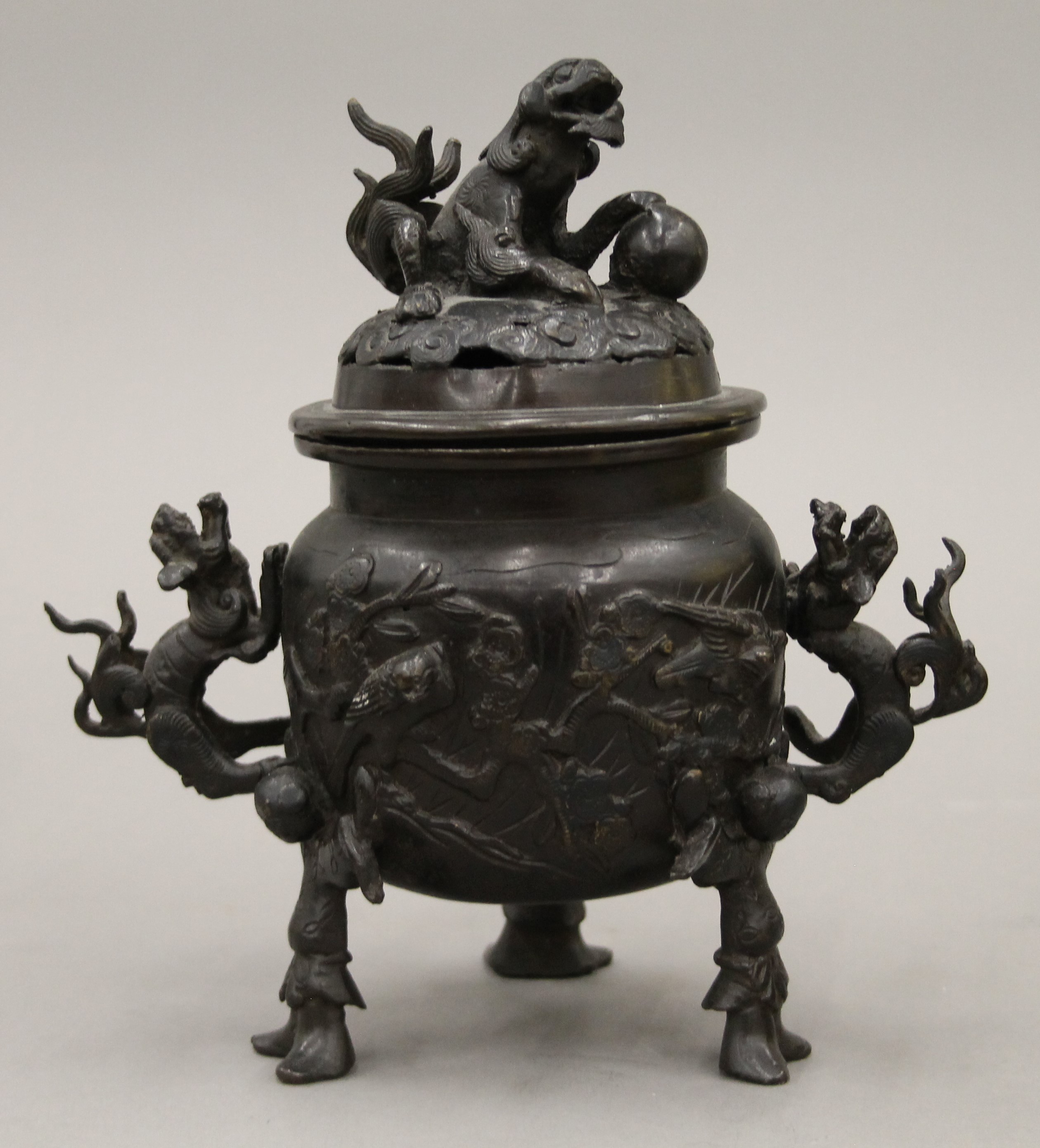 A Japanese patinated bronze tripod incense burner with dragon handles and pierced lid. 20 cm high. - Image 2 of 5