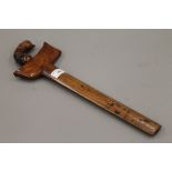 A Sumatran kris dagger with carved hardwood handle and sheath. 43 cm long.