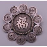 A Chinese silver brooch. 5 cm diameter.
