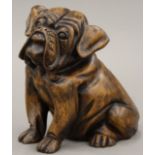 A carved wooden figure of a bull dog. 18 cm high.