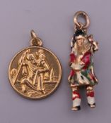 A 9 ct gold charm formed as a bag piper and a 9 ct gold St Christopher charm. 3.