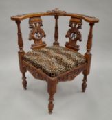 A 19th century carved walnut corner chair. 70.5 cm wide.