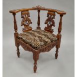 A 19th century carved walnut corner chair. 70.5 cm wide.