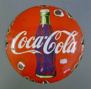 An enamel Coca Cola sign. 29 cm diameter.