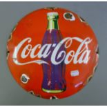 An enamel Coca Cola sign. 29 cm diameter.