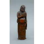 An 18th century Chinese bamboo carving of Buddha holding a toad. 19 cm high.
