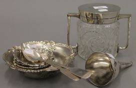 An EPNS and cut glass biscuit barrel, five dishes, two spoons and a Sheffield plate wine funnel.