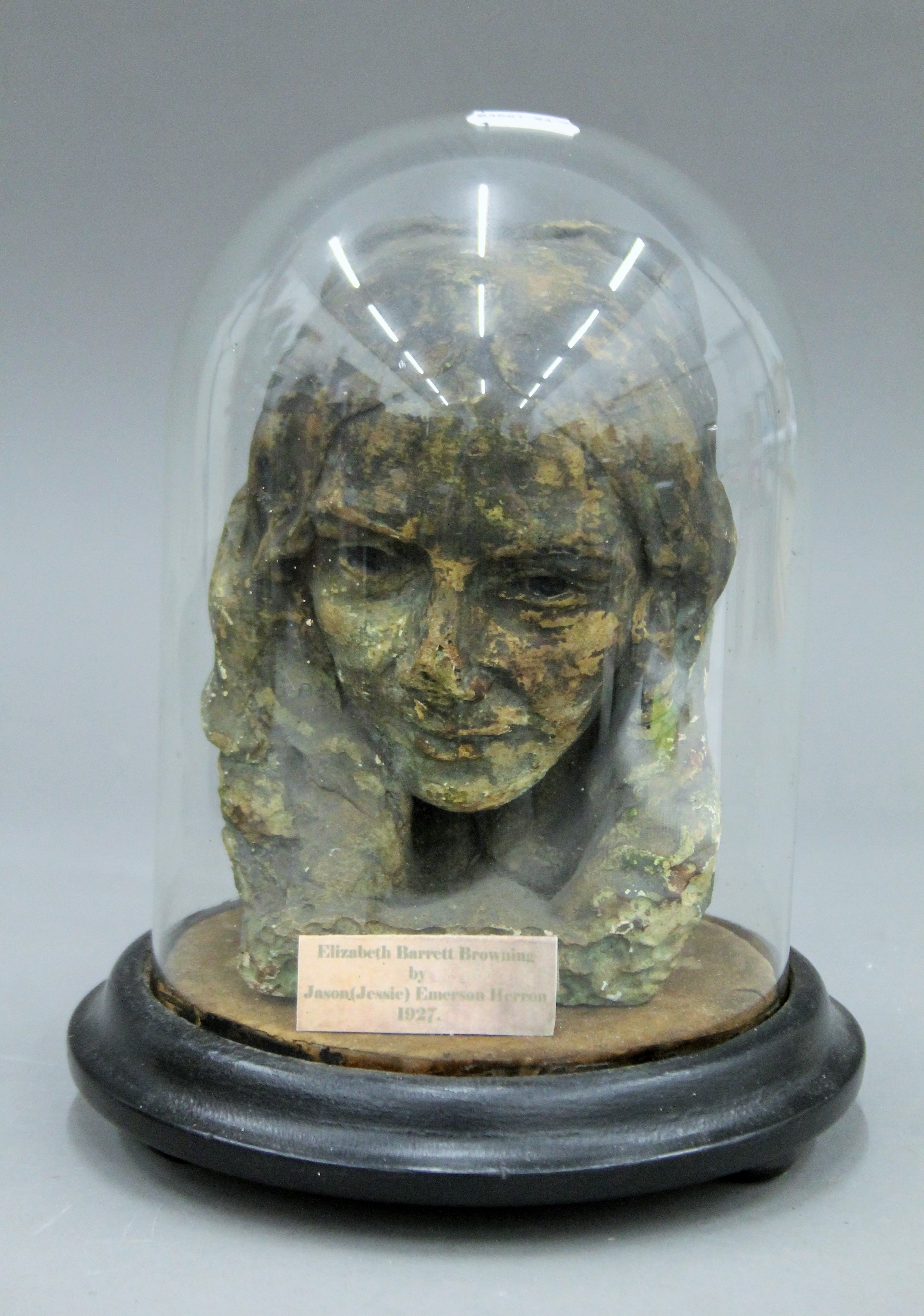 A plaster bust under a glass dome of Elizabeth Barrett Browning,