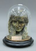 A plaster bust under a glass dome of Elizabeth Barrett Browning,