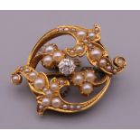 A Victorian unmarked gold diamond and pearl brooch. 2.5 cm wide. 5.6 grammes total weight.