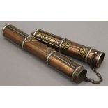 A Tibetan copper and brass scroll holder. 37 cm long.