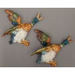 Two Beswick porcelain Mallard wall plaques. The largest 22 cm long.