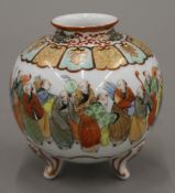 A Japanese vase decorated with figures, with four character mark to base. 13 cm high.
