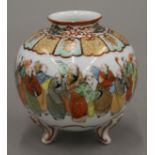 A Japanese vase decorated with figures, with four character mark to base. 13 cm high.