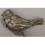 A silvered bronze bird form paperweight. 12 cm long.