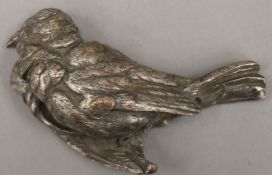 A silvered bronze bird form paperweight. 12 cm long.