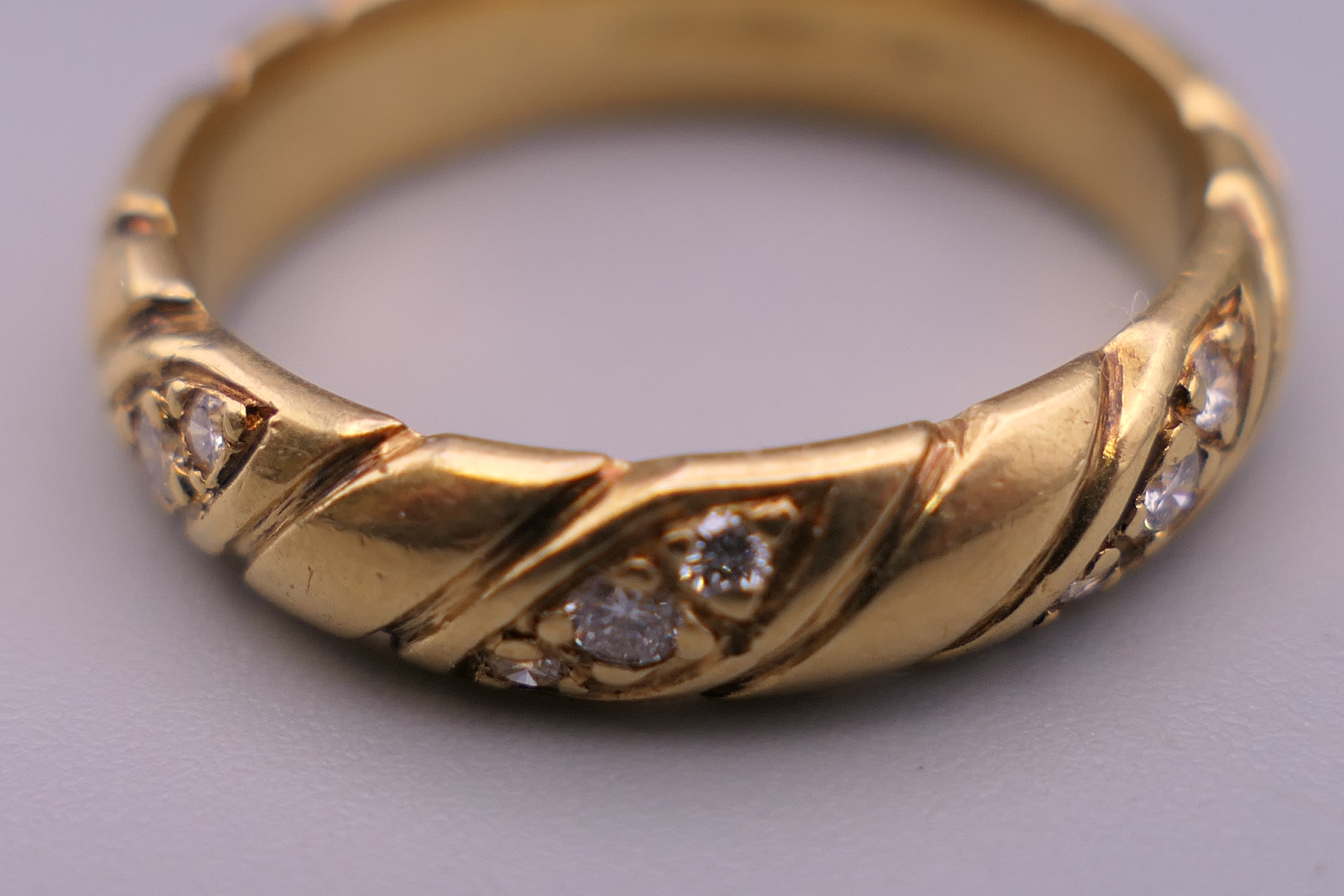 An 18 ct gold diamond set ring. Ring size P. 6.6 grammes total weight. - Image 6 of 10