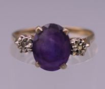 A 9 ct gold diamond and amethyst ring. Ring N/O. 1.7 grammes total weight.