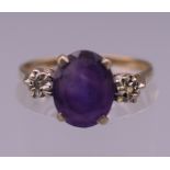 A 9 ct gold diamond and amethyst ring. Ring N/O. 1.7 grammes total weight.