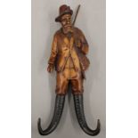 A Blackforest whip holder formed as a hunter. 26.5 cm high.