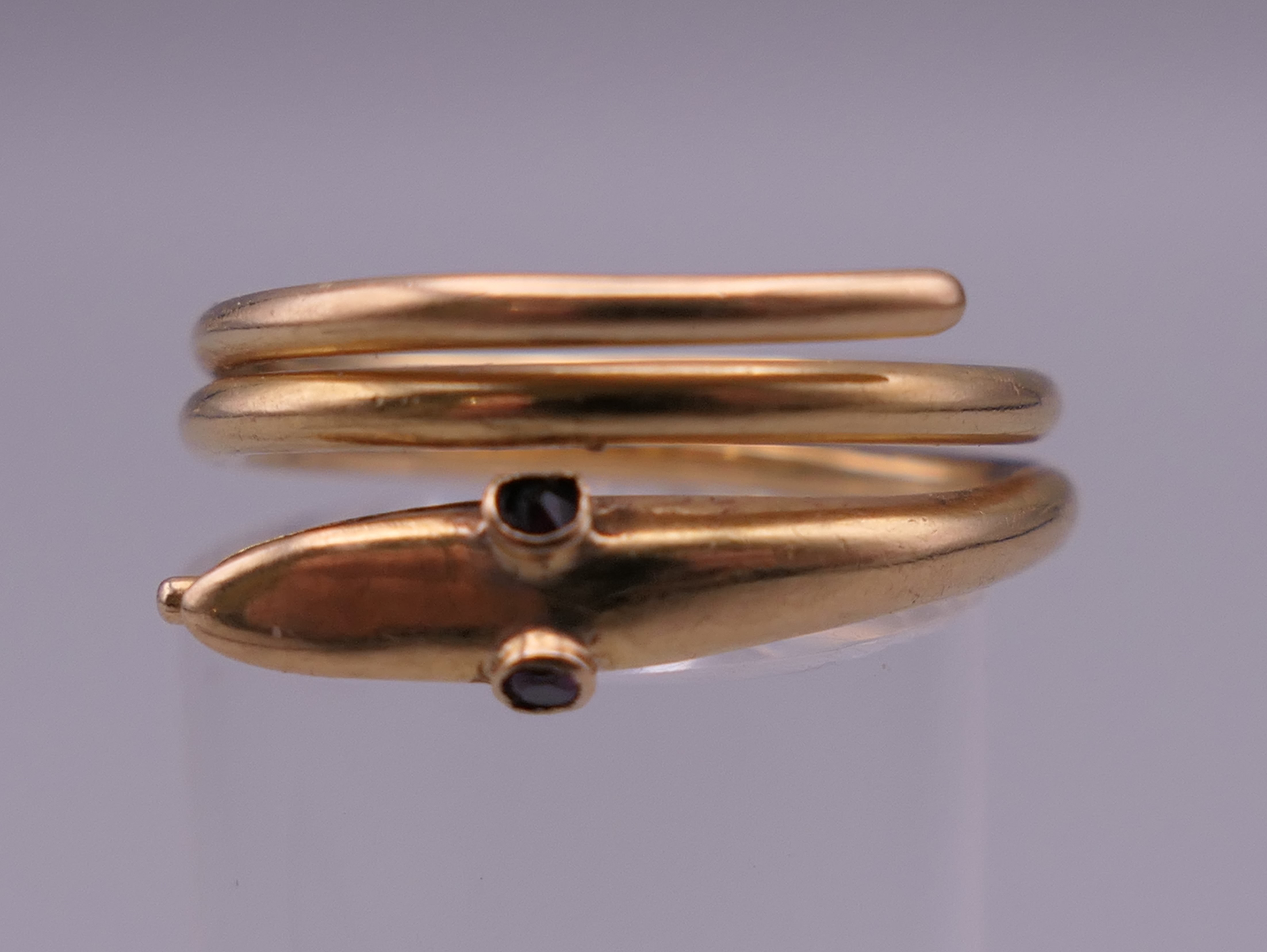 An 18 ct gold snake form ring. Ring size J/K. 5.5 grammes total weight.