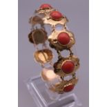 An 18 ct gold coral set bracelet. 20.3 grammes total weight.