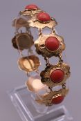 An 18 ct gold coral set bracelet. 20.3 grammes total weight.