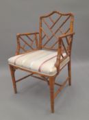 A faux bamboo open armchair. 56 cm wide.