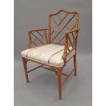 A faux bamboo open armchair. 56 cm wide.