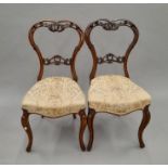 Two Victorian walnut dining chairs. 43 cm wide.