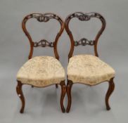 Two Victorian walnut dining chairs. 43 cm wide.