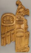 An American Indian wooden wall plaque, typically carved, signed by Sonny Wilson. 56 cm high.