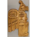 An American Indian wooden wall plaque, typically carved, signed by Sonny Wilson. 56 cm high.