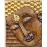 A carved painted wooden panel depicting Buddha. 51 x 40 cm.