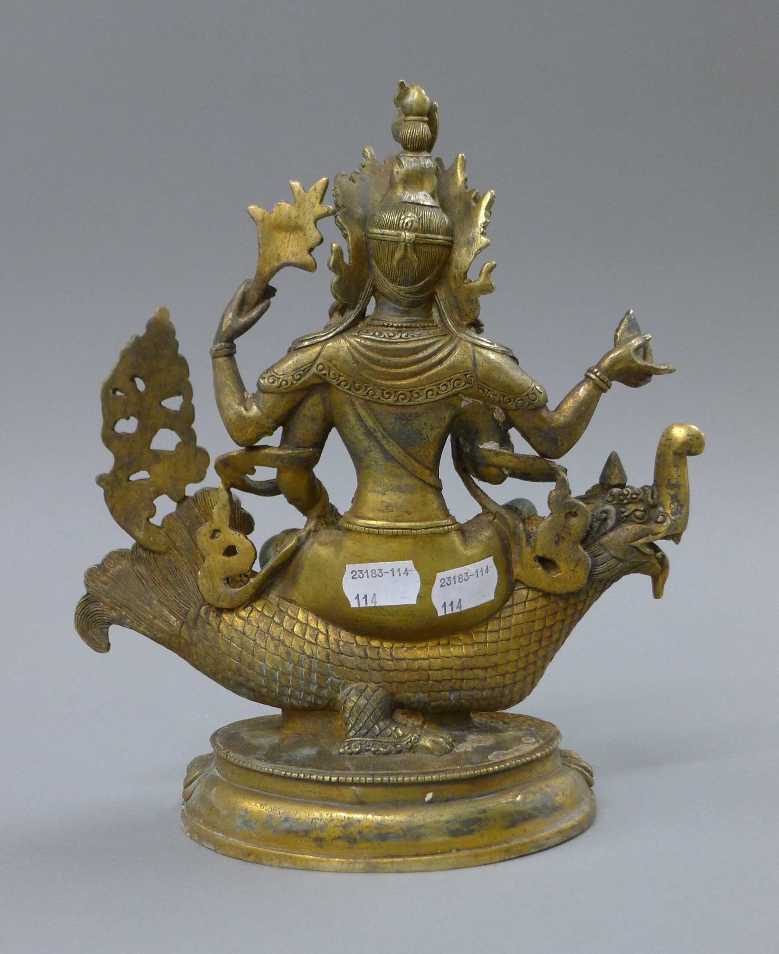 A gilt bronze model of Buddha decorated with coral and turquoise, seated on a mythical beast. 25. - Image 3 of 4