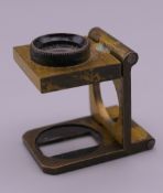 An antique brass carpet dealers magnifying glass.