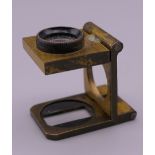 An antique brass carpet dealers magnifying glass.