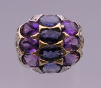 A 10 K gold ten stone amethyst and sapphire ring. Ring size N. 4.7 grammes total weight.