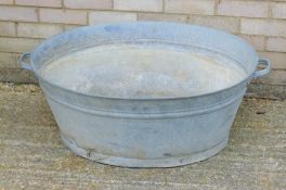 A large galvanized bath. 98 cm wide.